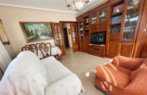 a living room with a couch and a tv at La Mies de Vallegon - 1801 in Isla