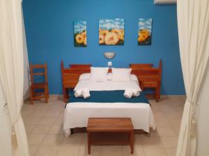 a blue bedroom with a bed and two chairs at Portal 17 Can Tort in Tossa de Mar