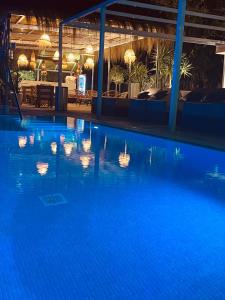 a swimming pool at night with lights on the water at Hotel Boutique Minister 4Sup in Port de Soller