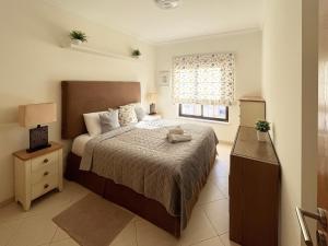 a bedroom with a large bed and a window at Sunset Lagos Apartment in Lagos