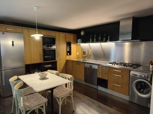 a kitchen with a table and chairs and a stove at CASA RURAL ALEGRE in La Fresneda