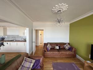 a living room with a couch and a kitchen at Fantastic 3 bedroom holiday home in Millport