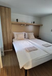 duże białe łóżko z dwoma ręcznikami w obiekcie Adria summer home w Biogradzie na Moru