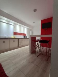 a large kitchen with a counter and a table at Edificio Castelli 90 in Chumillo