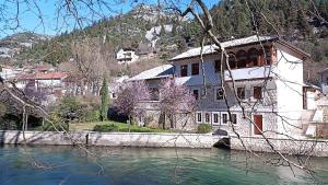 a building on the side of a river at Apartmani Stolac in Stolac