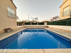 a swimming pool in front of a building at Bga Rentals Aini in Cambrils
