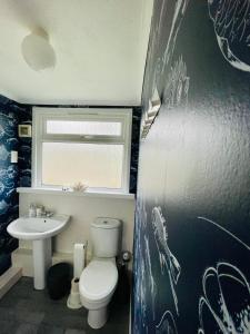 a bathroom with a toilet and a sink at “SEA HEAVEN “ chalet in Sandown Bay Holiday Park in Brading