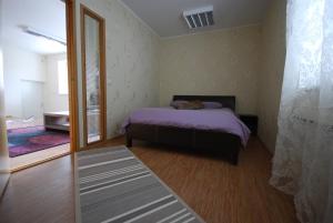 a bedroom with a bed and a large window at City Apartment in Kuressaare