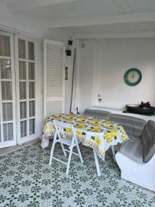 a room with a table and a couch and a table and chairs at channel house in Ischia