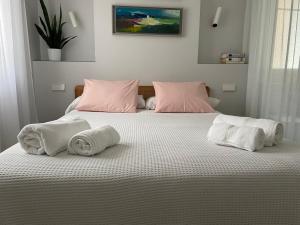a bedroom with a bed with towels on it at Burgos Señorial by Exclusive Burgos Apartments in Burgos