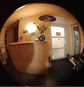 a hallway with a vase of flowers on a table at Landhaus Effeld in Wassenberg