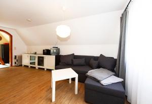 a living room with a couch and a table at Ferienhaus Katharina in Malschwitz +9 photos