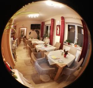 a dining room with tables and chairs and a mirror at Landhaus Effeld in Wassenberg +37 photos