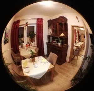 a dining room with a table and chairs and a mirror at Landhaus Effeld in Wassenberg