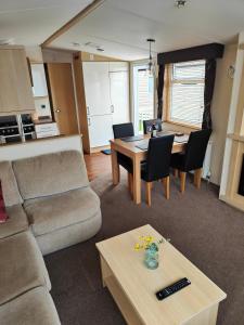 a living room with a couch and a table at Holiday home sleeps six in Poole