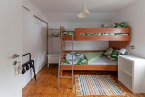 1 Schlafzimmer mit 2 Etagenbetten und einem Teppich in der Unterkunft Vrtnarjeva hiša, The Gardener's Cottage in Radovljica