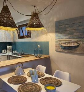 a kitchen with a table with a tea kettle on it at Casa frente al mar en Miami Playa 2hab in Miami Platja