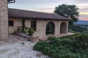 a small stone house on top of a hill at Casa nella campagna Umbra in San Terenziano