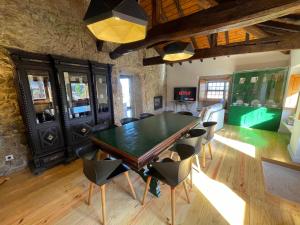 a dining room with a green table and chairs at AltaVista in Vitorino dos Piães