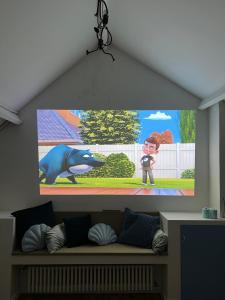 a tv screen with a picture of a boy and a bear at Charmante Art Deco rijwoning in Ostend