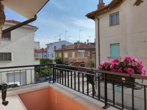 a balcony with pink flowers on a building at Casa Angelina in Grado