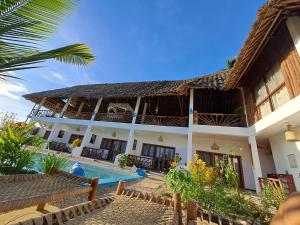 a villa with a swimming pool and a resort at Villa Adelina Zanzibar in Zanzibar City
