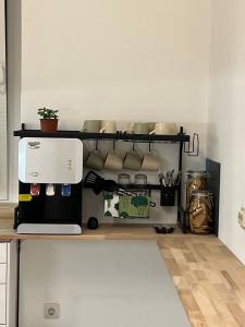 a kitchen with a counter with a coffee maker at Cabbage Hostel in Belgrade
