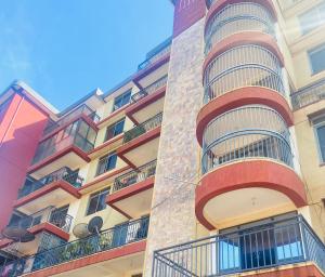 a building with balconies on the side of it at J&R - Lovely two bedroom apartment in Jinja. in Jinja