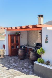 a patio with a bar and some wine barrels at LA CAÑADA in Tiscamanita