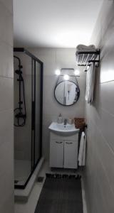 a bathroom with a sink and a mirror at Stegna Rita's apartment in Archangelos