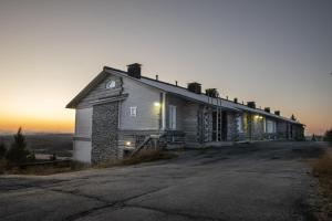 ein altes Haus auf einem Hügel bei Sonnenuntergang in der Unterkunft Tunturihuoneisto LAAKEUS in Syöte