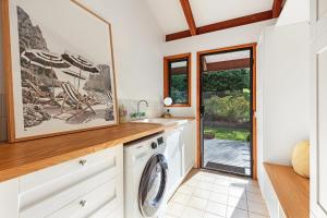 a laundry room with a washer and dryer at Hinterland family getaway in Maleny
