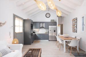 Olivea Premium Holiday Homes في Stavros: مطبخ وغرفة طعام مع طاولة وكراسي