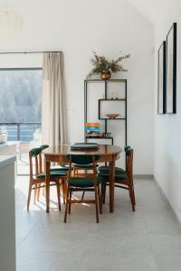 a dining room with a wooden table and chairs at Baza Tlen in Zachełmie