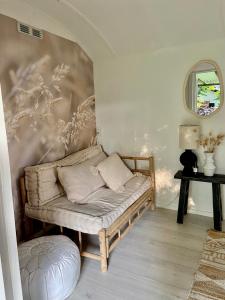 ein Sofa in einem Zimmer mit einer Wand in der Unterkunft Hofstede klein Rozendaal, Tuinhuis in Asch