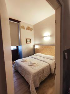a small bedroom with a bed in a room at APARTMENT STAZIONE in Bergamo