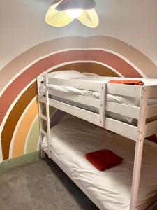 a bunk bed with a rainbow painted on the wall at 3 Bedroom Spacious Seaside Apartment with Estuary Views in Southend-on-Sea