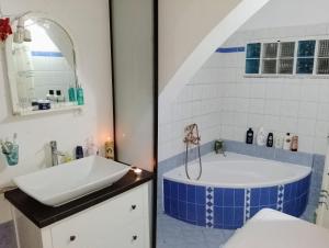 a bathroom with a tub and a sink at the ART HOUSE photo museum in Epanomi