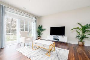 a living room with a tv and a coffee table at Stylish 1BR in at the Crossing in Indianapolis
