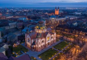 an aerial view of a building in a city at night at Lena Apartman in Subotica