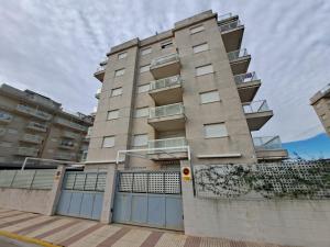 a tall apartment building with a fence in front of it at Ideal apartamento in Daimuz