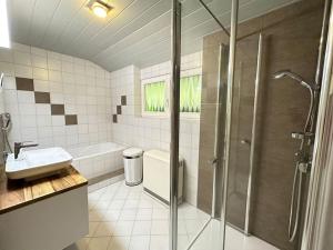 a bathroom with a shower and a sink at Le Bain du Corbeau - Schwarzwald-Villa Alpirsbach in Alpirsbach +45 photos