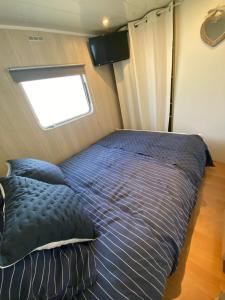 a bed in a small room with a window at Chalet de Provence in Aix-en-Provence