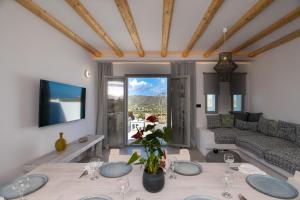 a living room with a table and a couch at Mykonos Village in Ano Mera