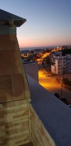 a view of a city at sunset from a building at Apartment Amira Smir in Riffiene