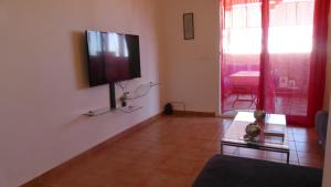 a living room with a flat screen tv on a wall at Apartment Amira Smir in Riffiene
