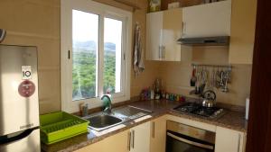 a kitchen with a sink and a window at Apartment Amira Smir in Riffiene