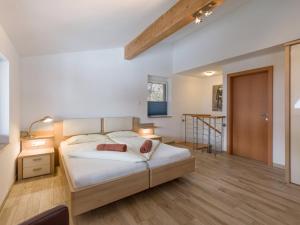 a bedroom with a large bed and a staircase at Blaiken Appartements in Scheffau am Wilden Kaiser in Scheffau am Wilden Kaiser