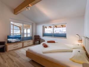 A bed or beds in a room at Blaiken Appartements in Scheffau am Wilden Kaiser