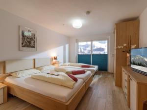 A bed or beds in a room at Blaiken Appartements in Scheffau am Wilden Kaiser